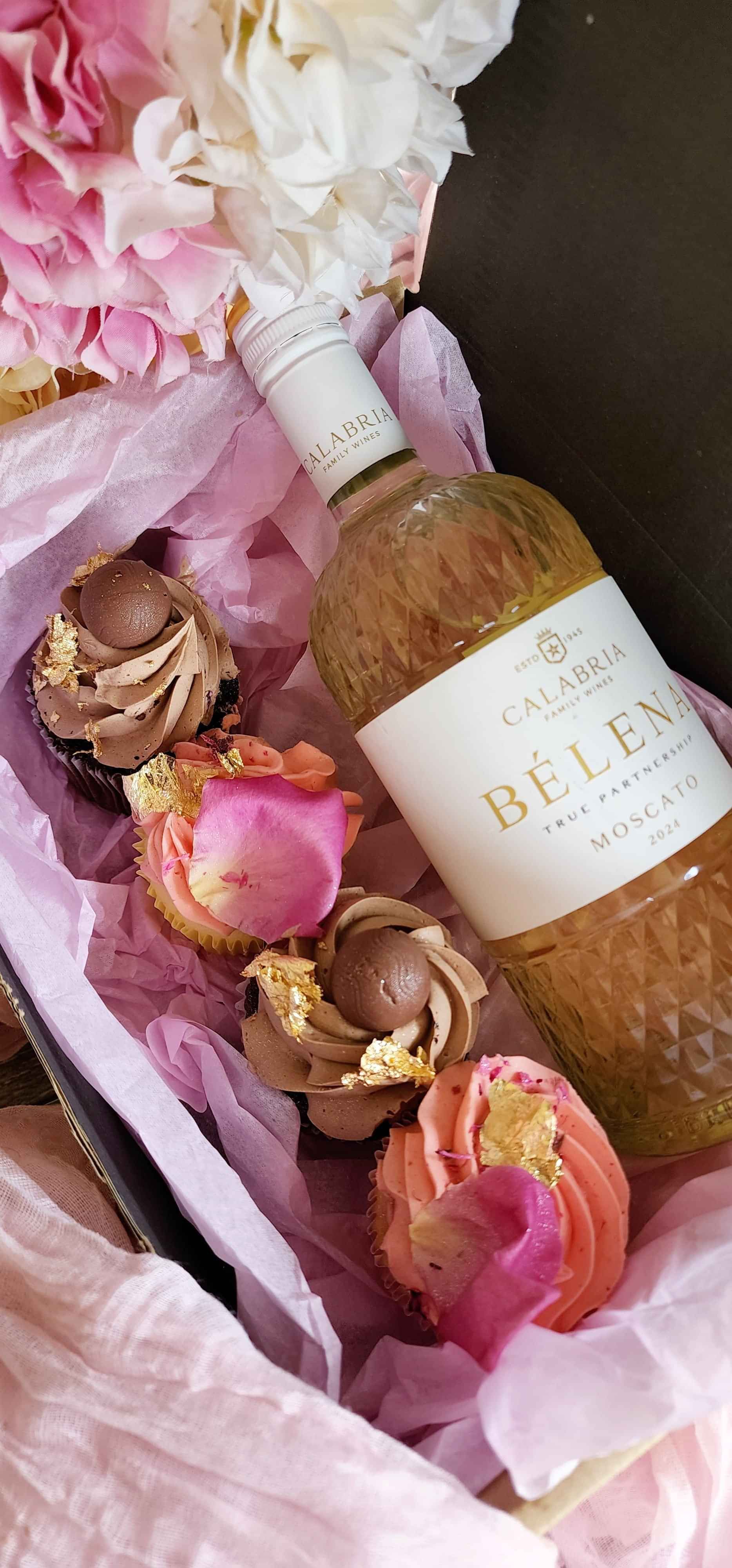 A luxury gift box with cupcakes and a bottle of Moscato wine