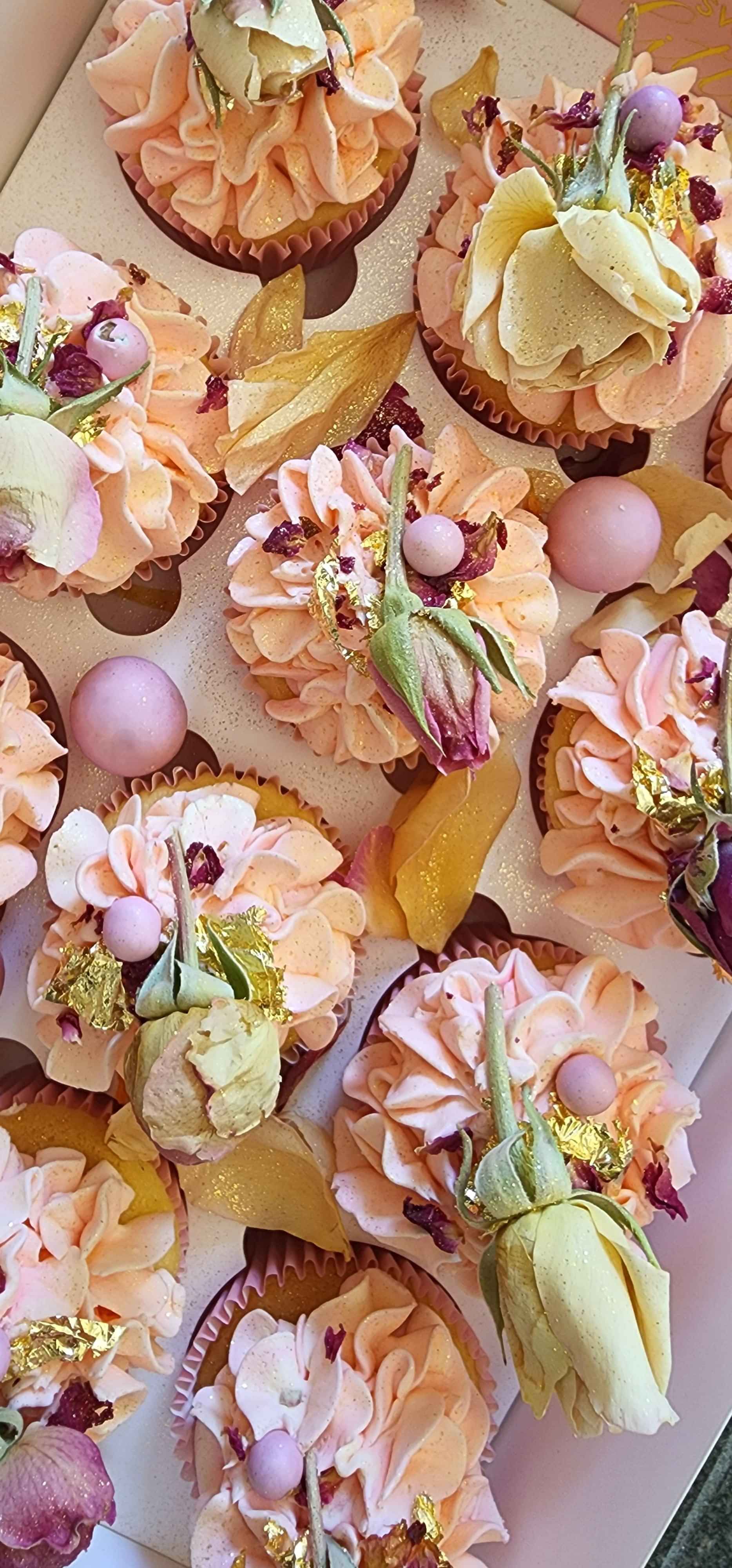 Pink and purple cupcakes with edible roses and gold sprinkles