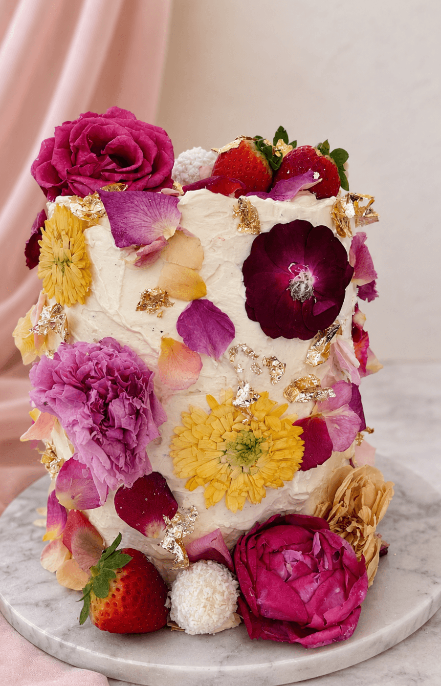 Luxury Signature Cake with vanilla buttercream finish, and delicate edible colourful blooms