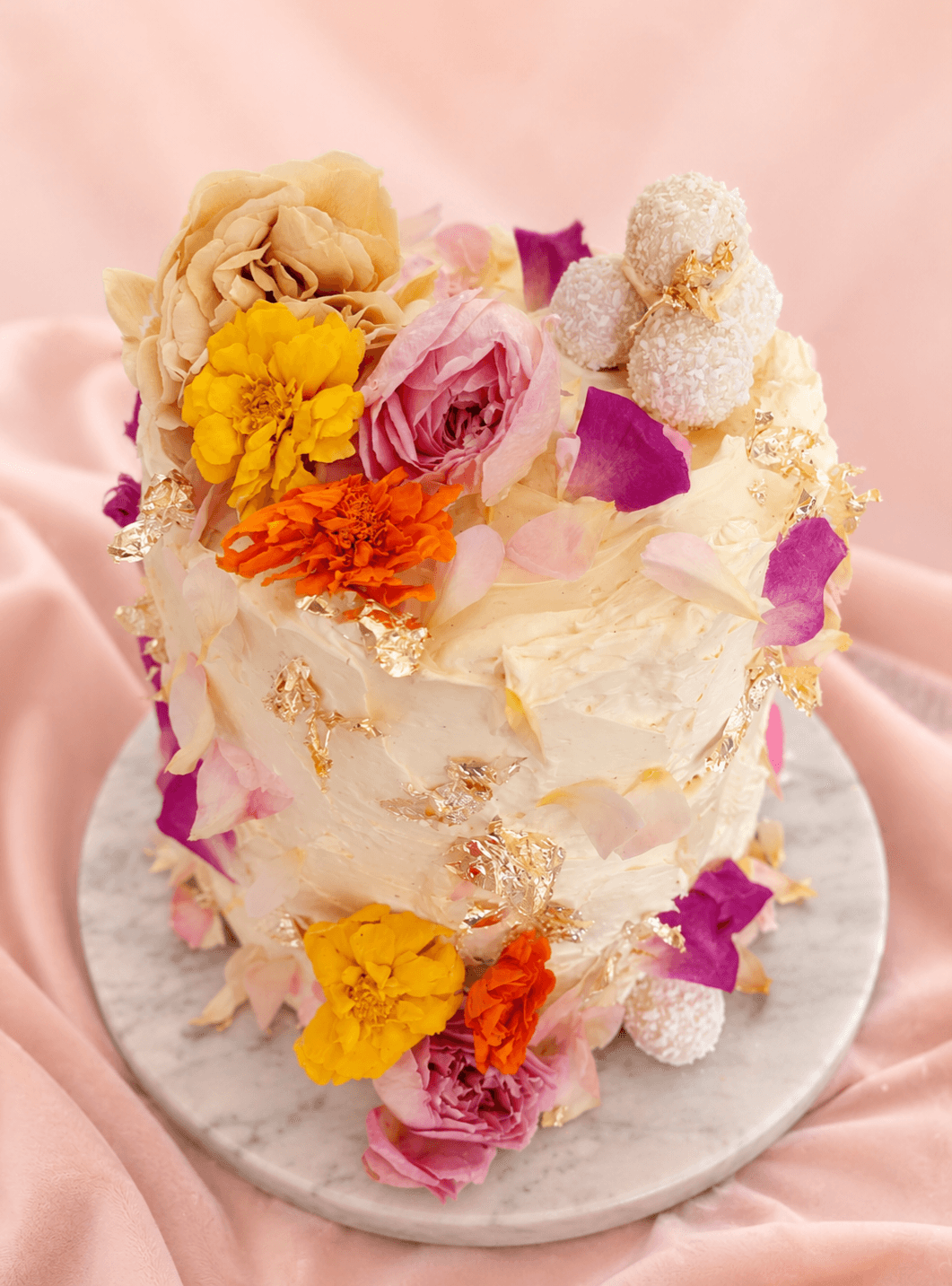 Luxury cakes with dried edible flowers and matching cupcakes with flowers