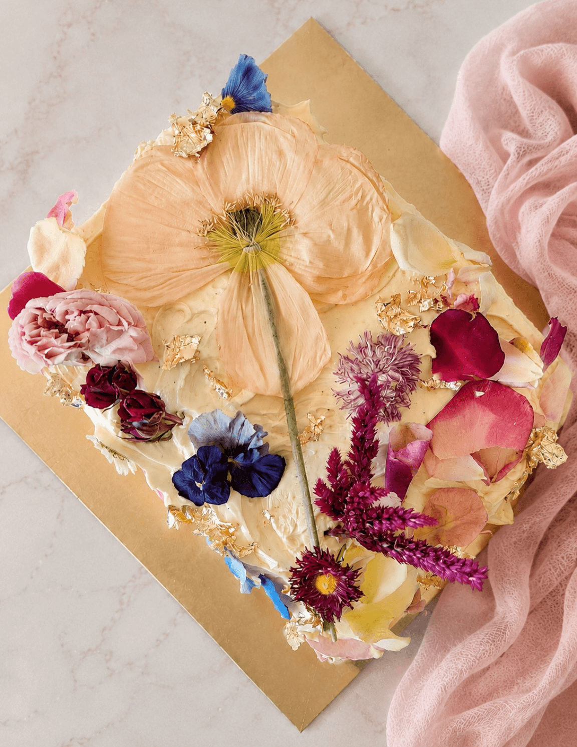 Luxury cakes with dried edible flowers and matching cupcakes with flowers