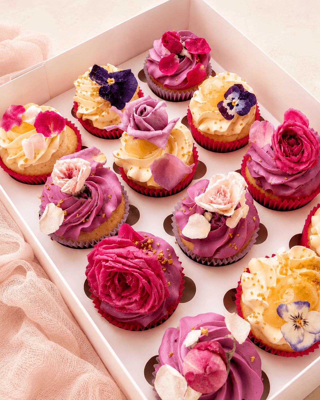 Pretty cupcakes with edible flowers on top