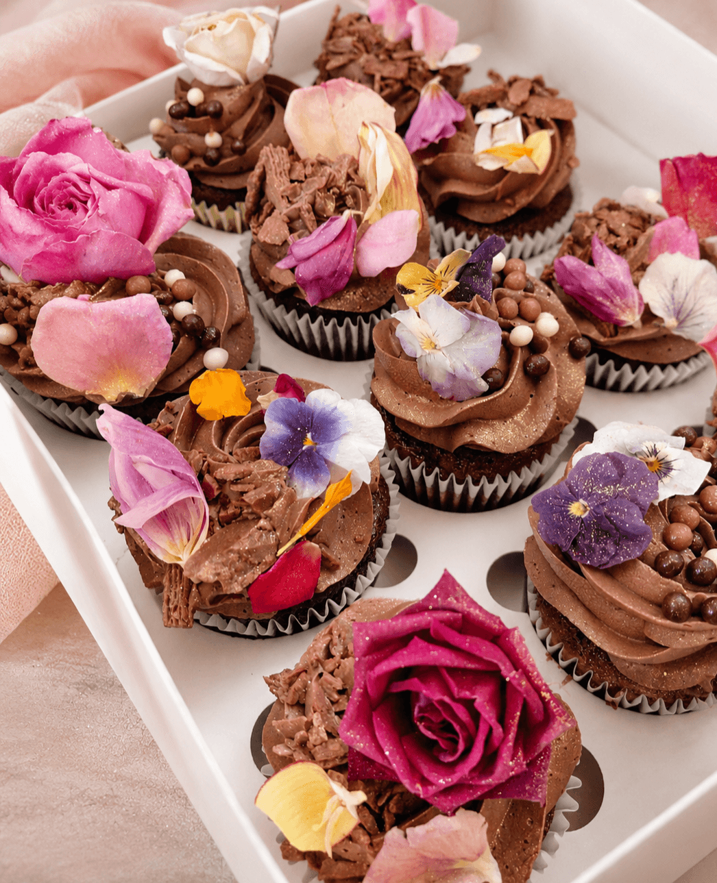 Chocolate cupcakes with edible flowers on top