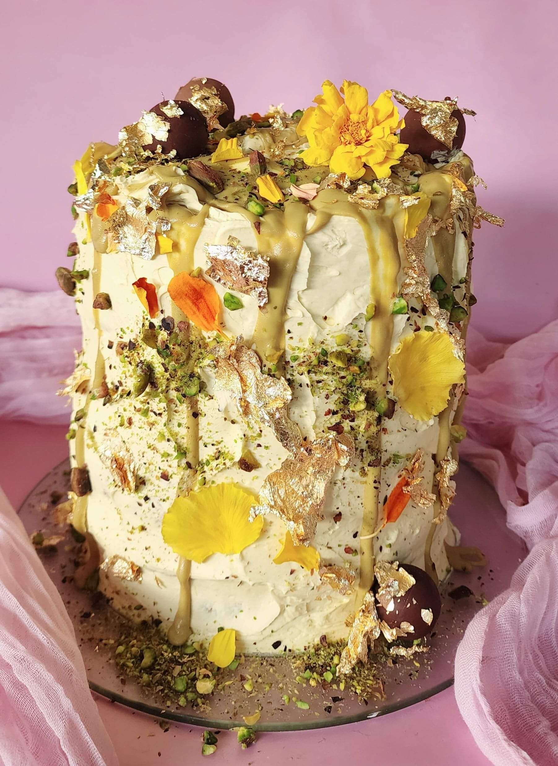 A vanilla and pistachio cake for a special occasion. Vanilla cake, pistachio buttercream, pistachio sauce and edible flowers