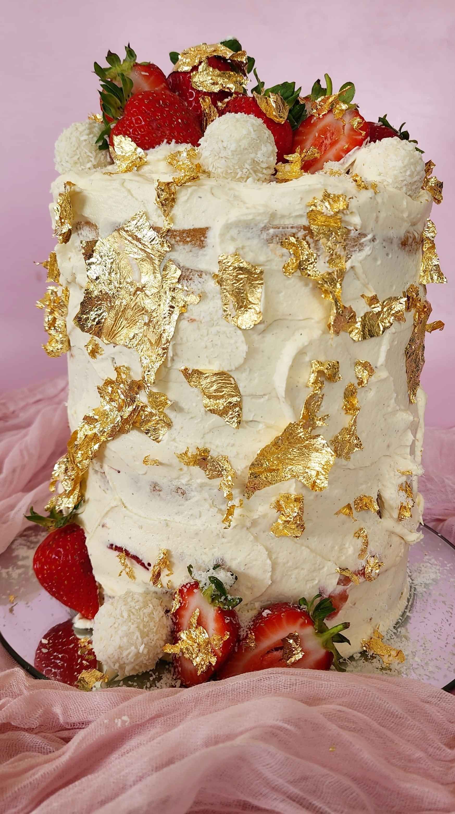 A classic Victoria sponge cake with jam and fresh strawberries with subtle touches of gold leaf