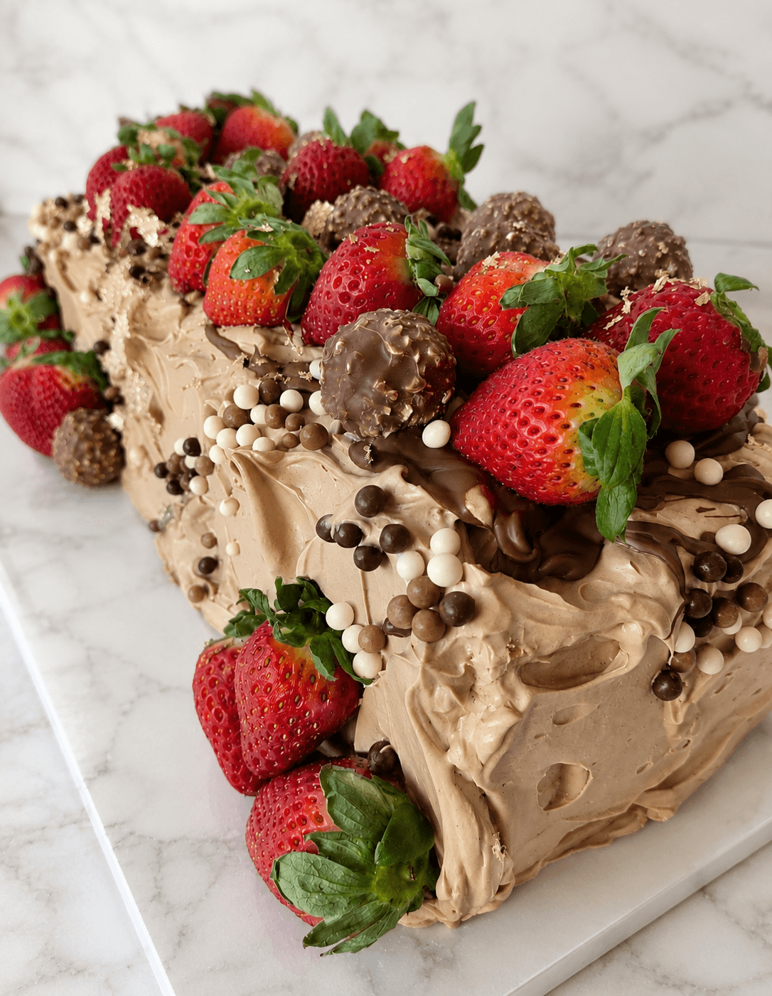 Indulgent Ferrero Rocher and strawberry cake.