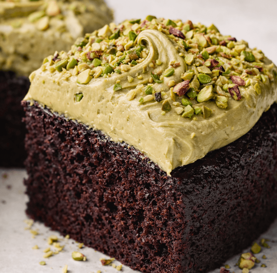 A luxury chocolate and pistachio slab cake. Chocolate cake topped with a luscious pistachio buttercream and chopped pistachios