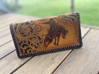 Leather carved saddle bronc purse