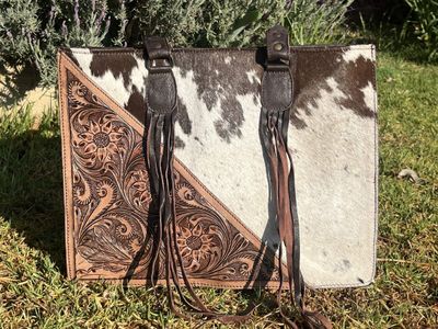 Tooled leather handbag with cowhide