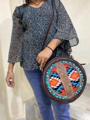 Round leather handbag with aztec woollen design