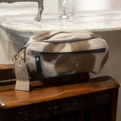 Tan/white cowhide toiletry bag