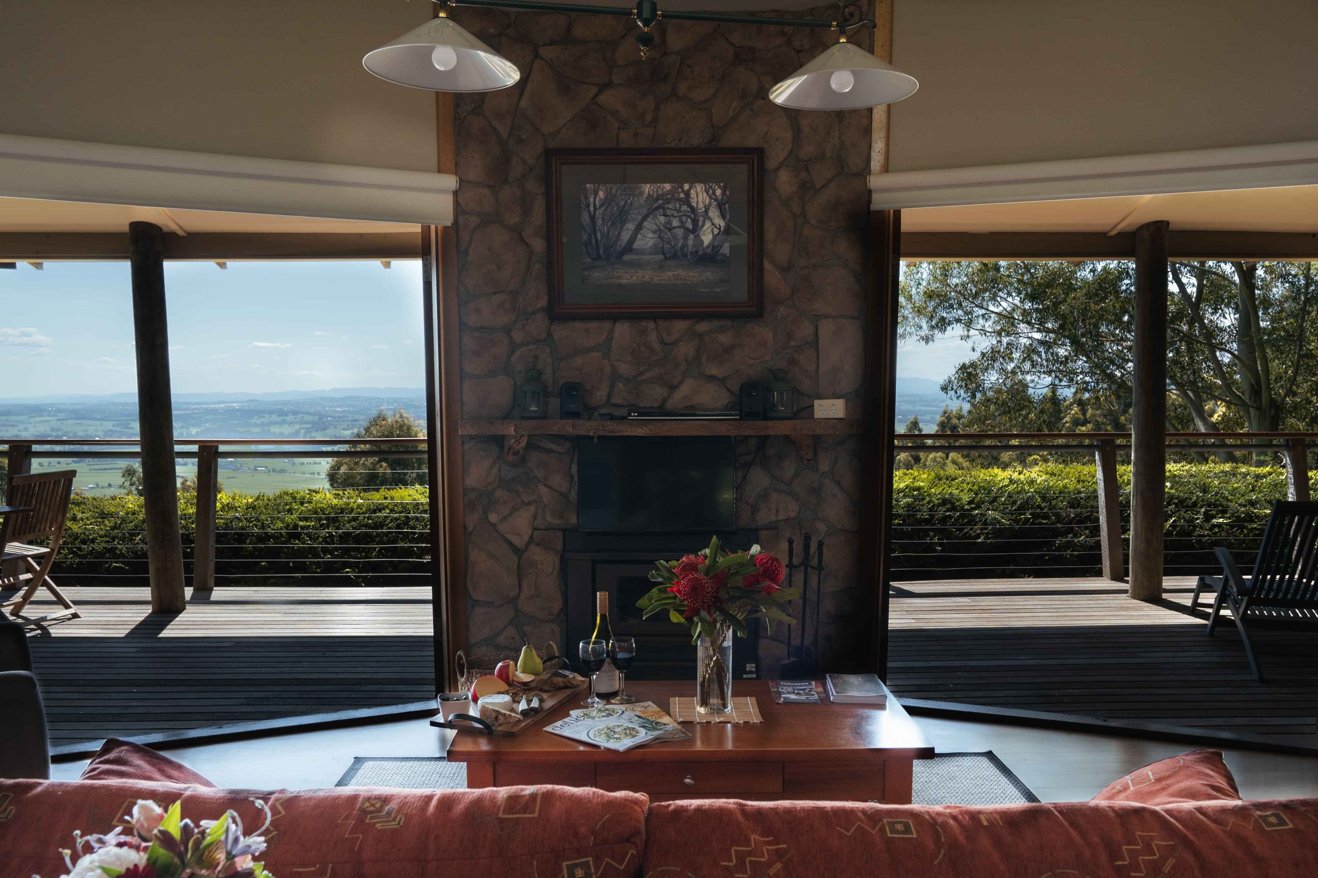 couch view from inside Taronga Cottage showing expansive valley views and deck