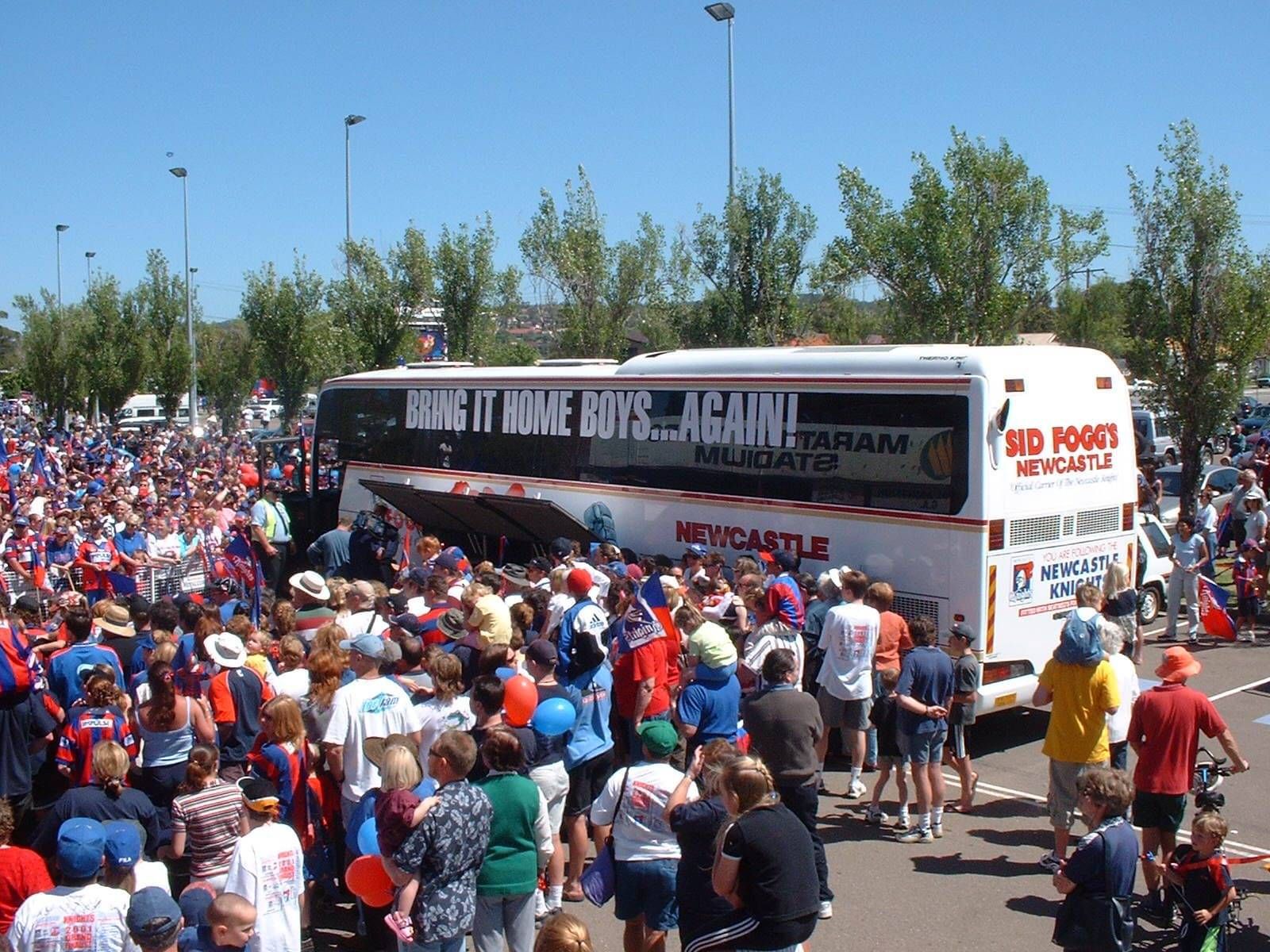 Sid Fogg's bus surrounded by a crowd of people