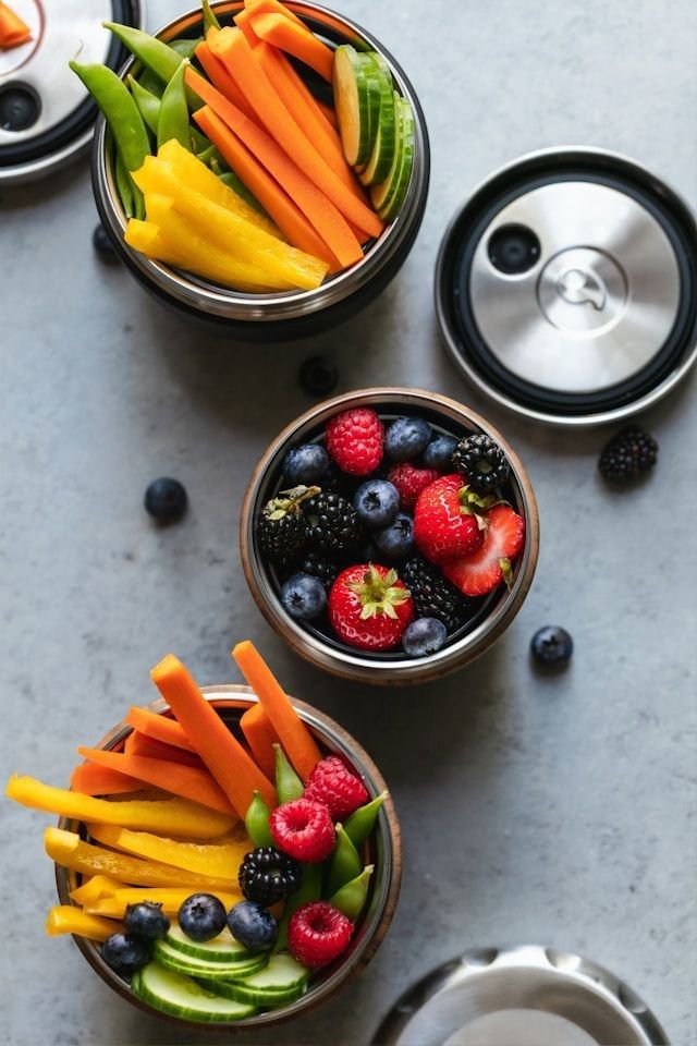 Fresh fruit and sliced up vegetables in containers.