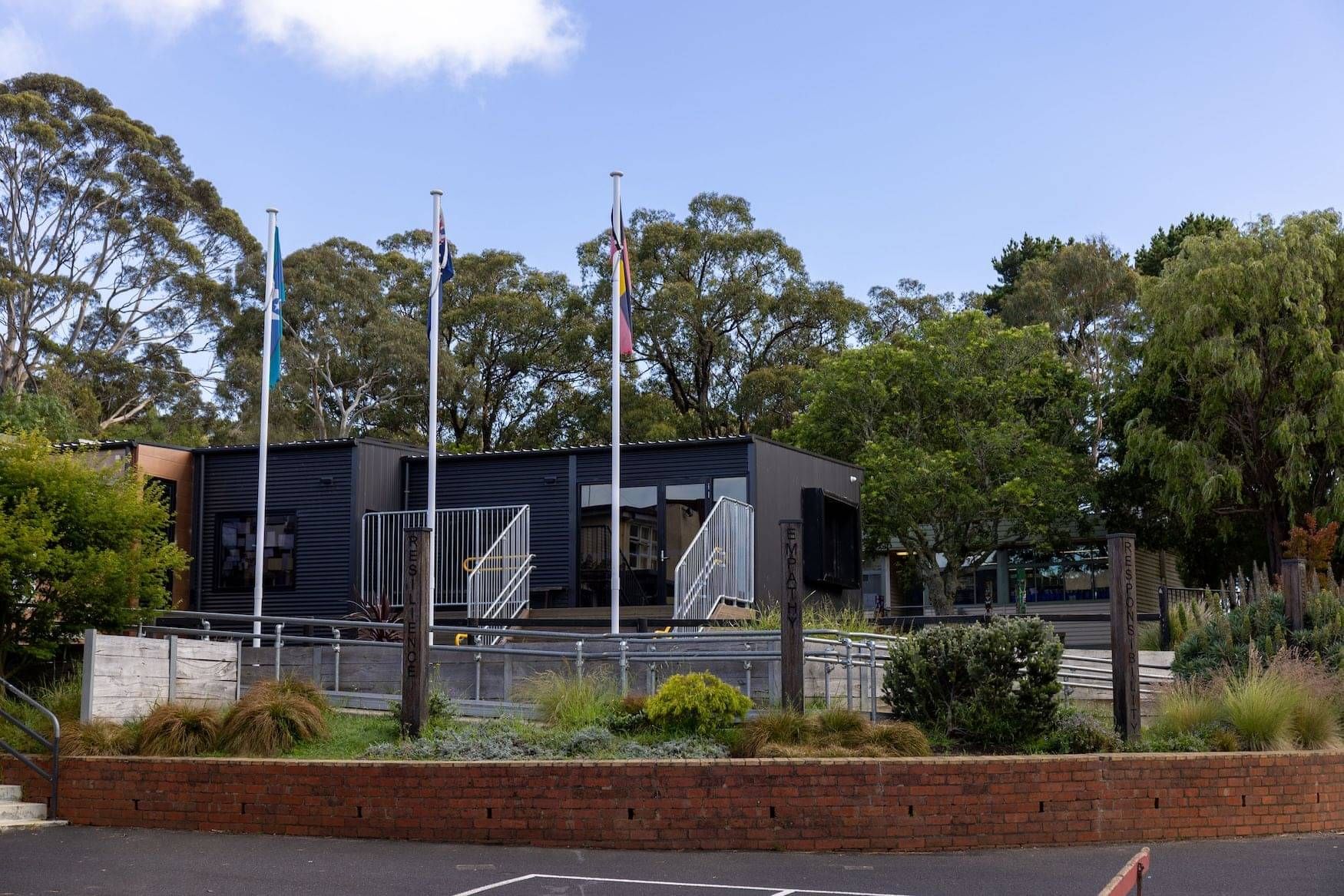 School flags infront of buildings at Red Hill Consolidated School Mornington Peninsula, Victoria.