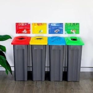 Recycling station image, showing four 60L slim multisort bins side-by-side, grey bases and a red, yellow, blue and green lid 